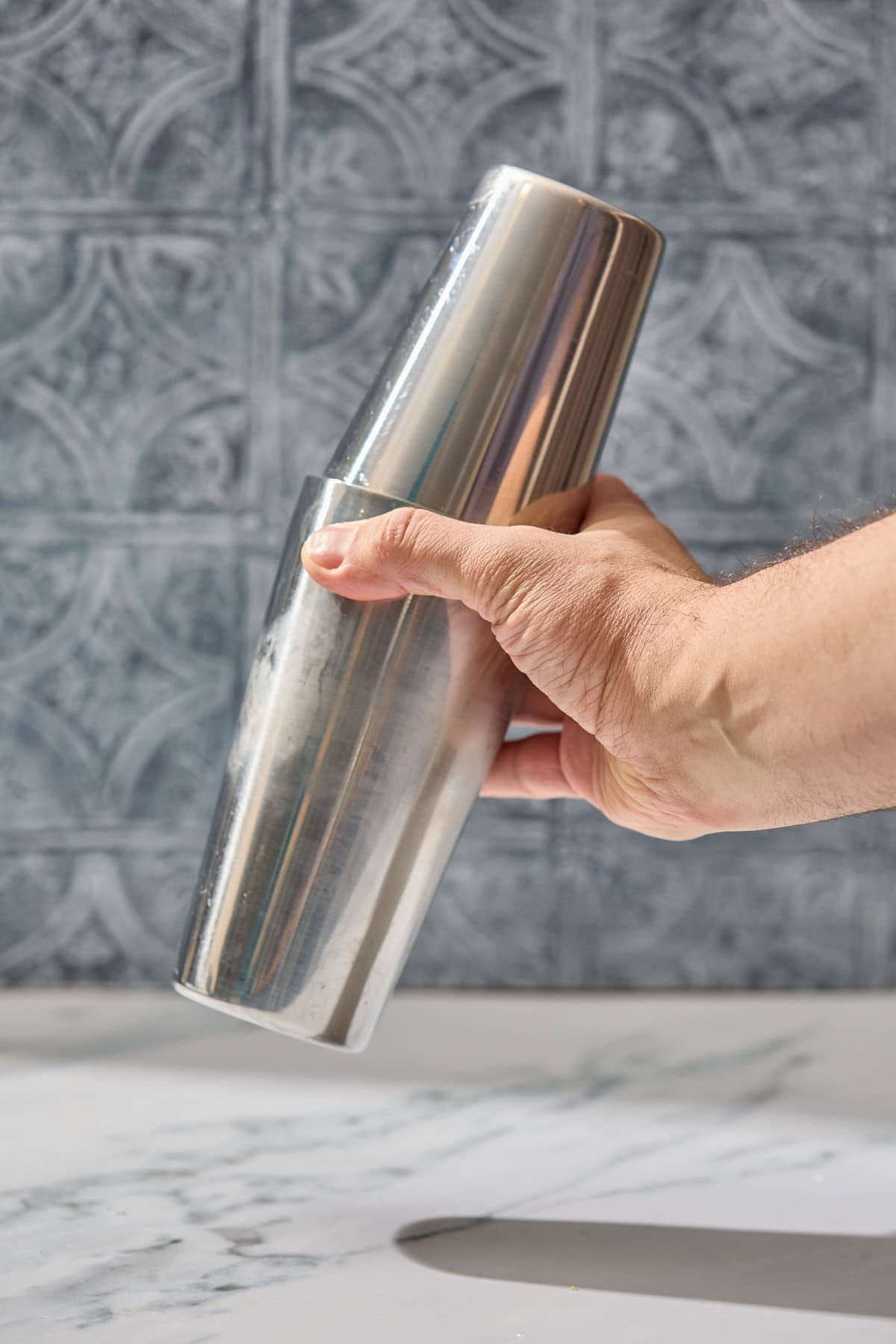 a cocktail shaker being shook