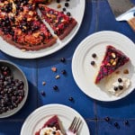 plates of black currant cake with a bowl of blackcurrants