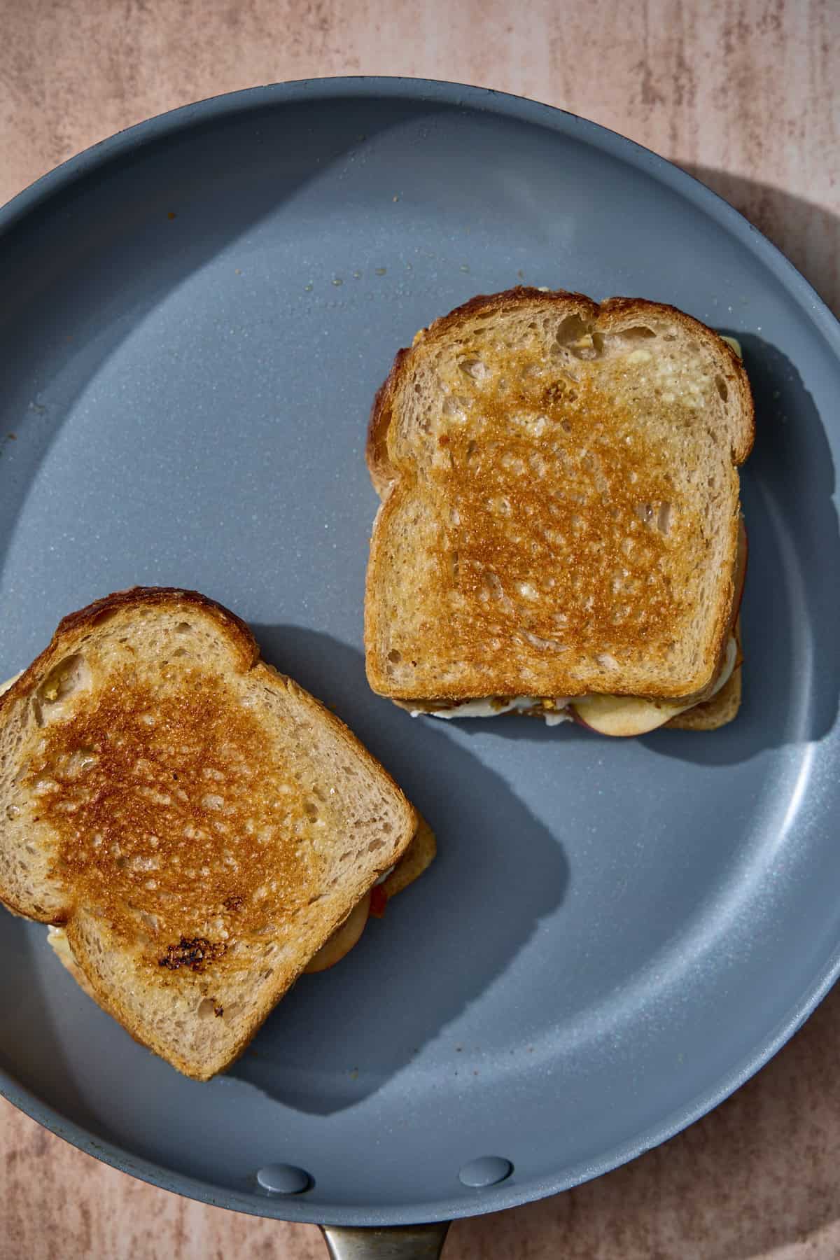 browned grilled cheese sandwiches in a pan