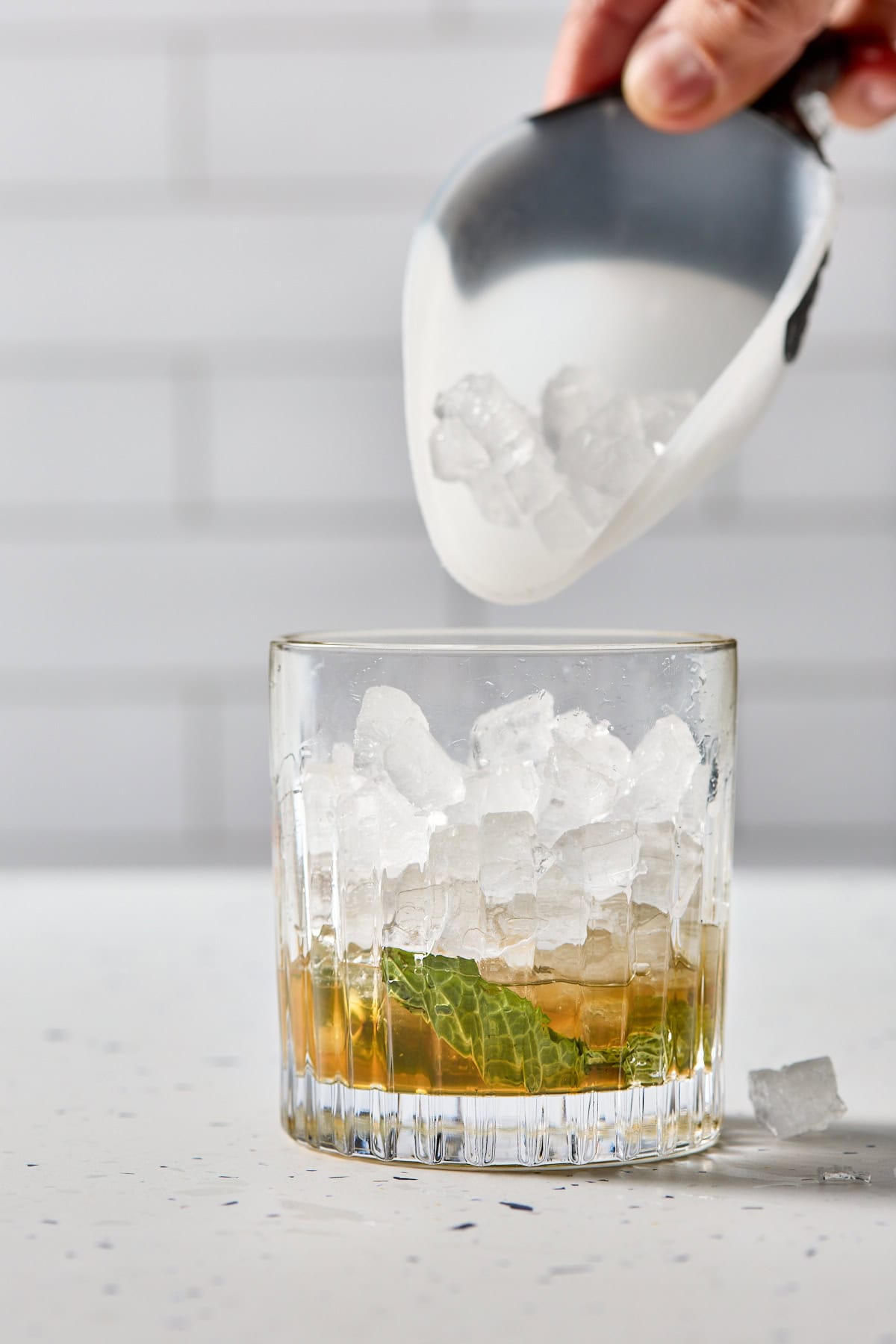 ice being poured into the cocktail