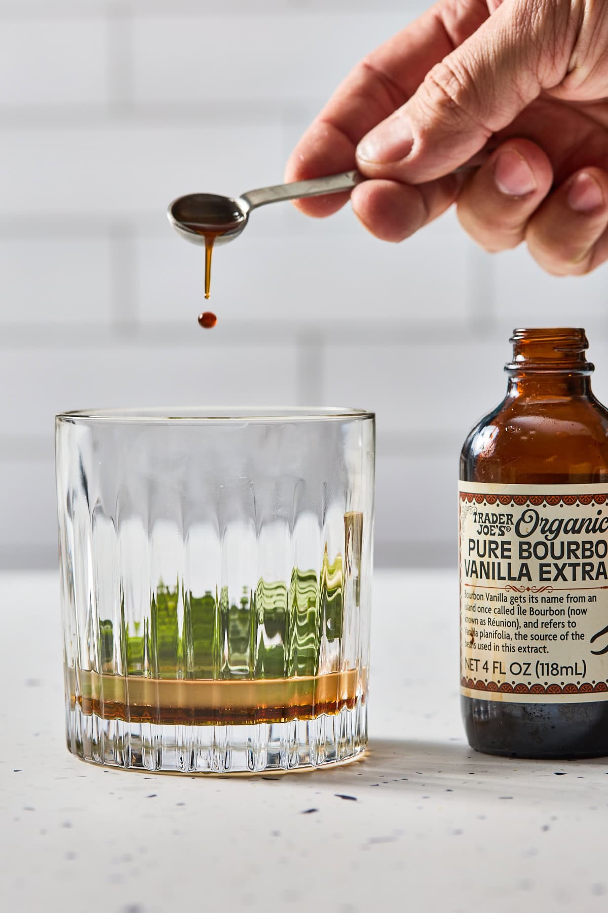 vanilla being poured into the cocktail glass