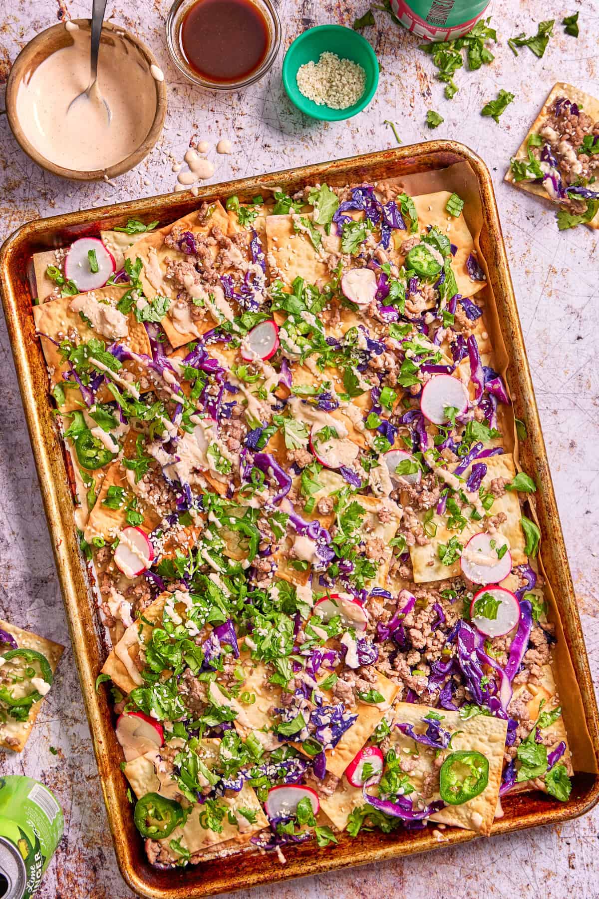 a tray of nachos with wontons and pork and cabbage