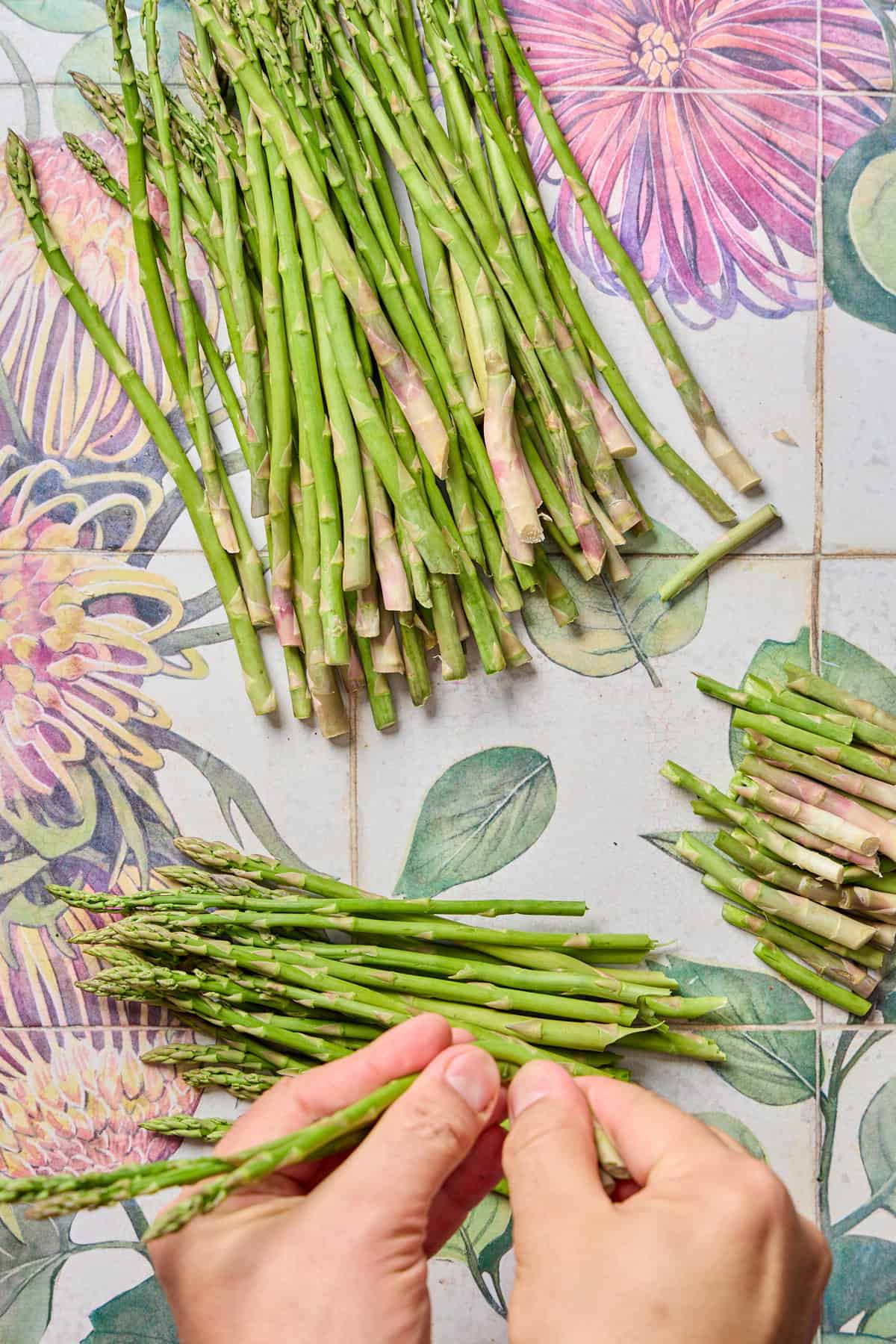 asparagus being trimmed and prepped on a counter