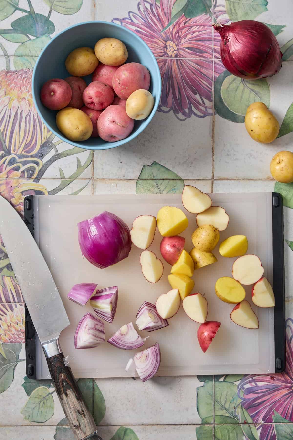 onions and potatoes being chopped on a cutting board