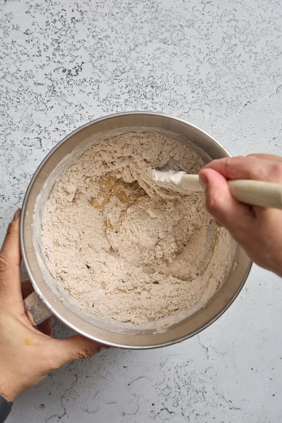 dry ingredients being stirred into wet in a bowl