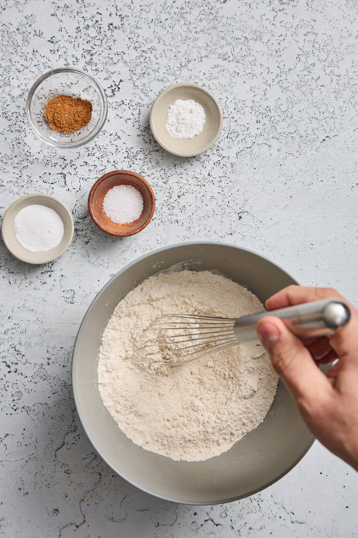 dry ingredients being whisked together in a mixing bowl