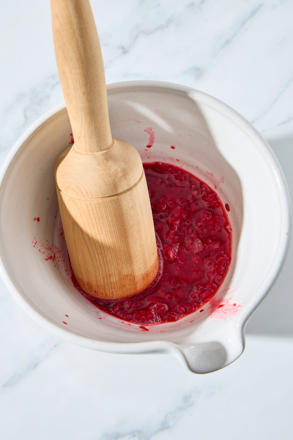 raspberries being muddled