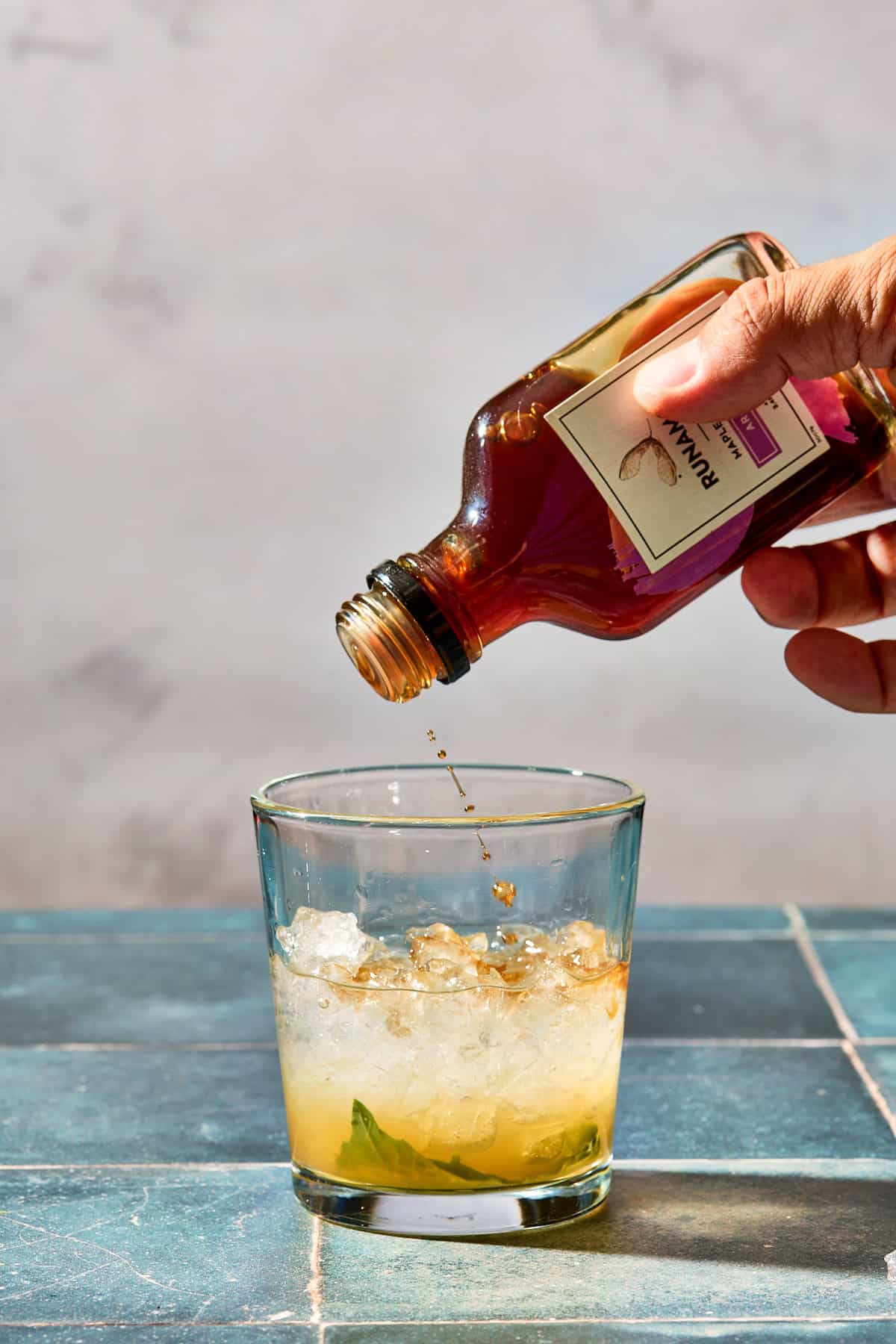 bitters being shook into the cocktail