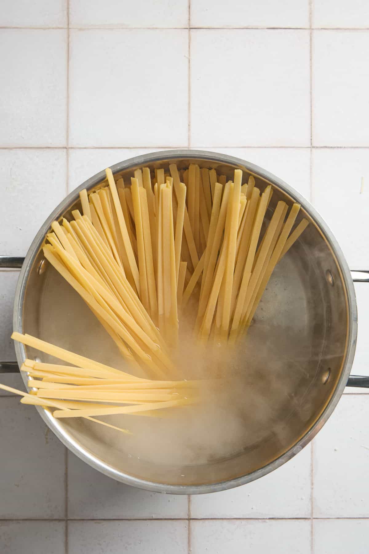 a large pot of steaming water with pasta